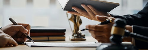 Two People Reviewing and Signing Documents