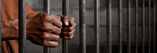 Prisoner Holding Jail Bars