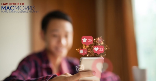 blurred picture of a young man on a phone with social media icons above it